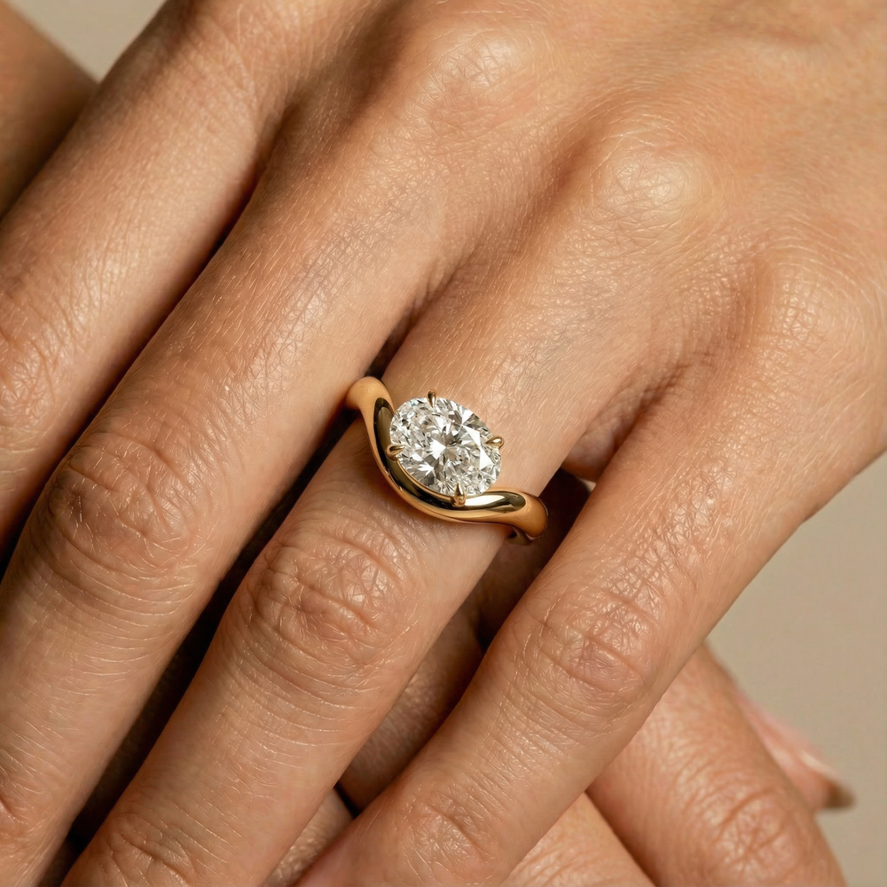 Close-up of a hand wearing a gold diamond engagement ring
