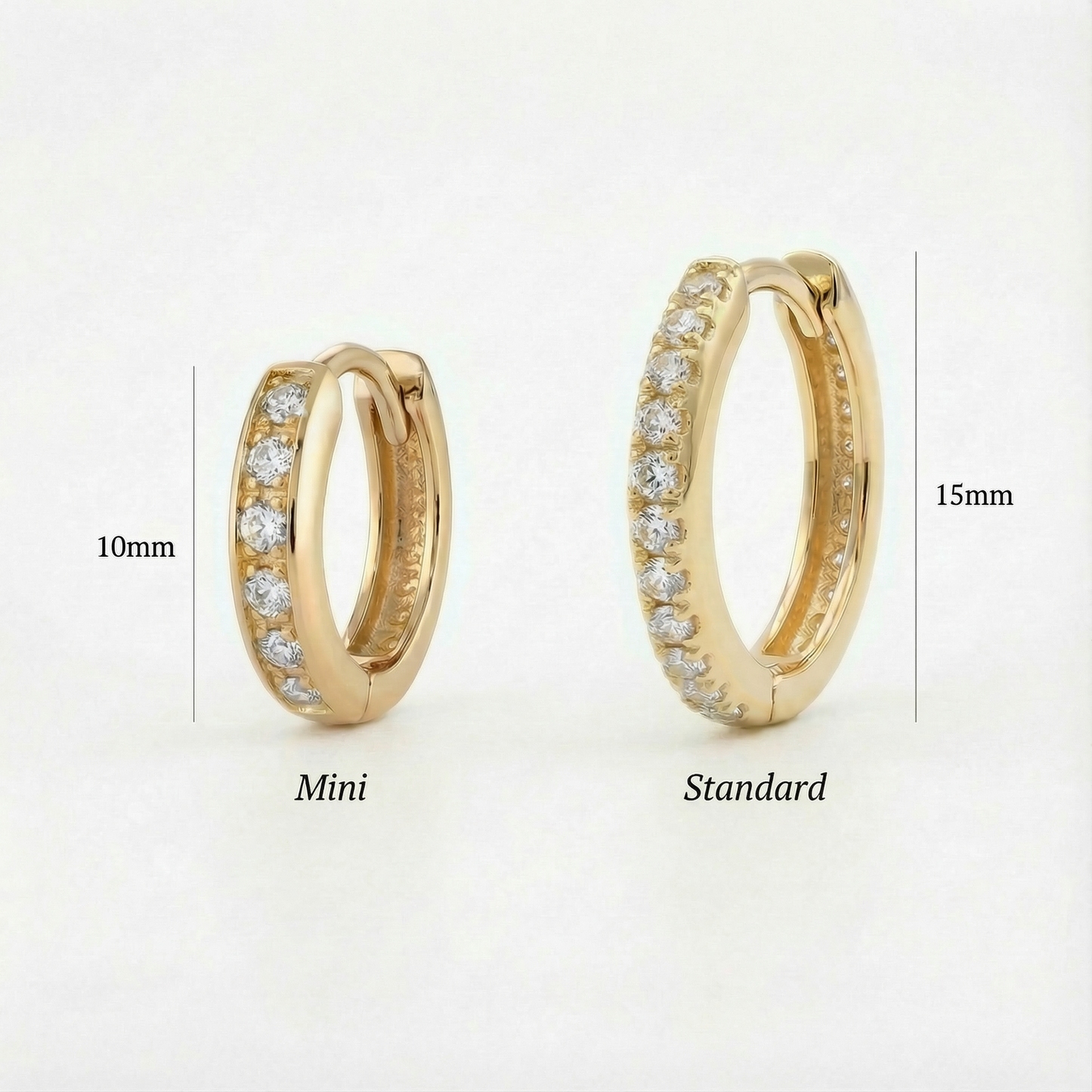 
                  
                    Two gold hoop earrings labeled 'Mini' and 'Standard' on a white background.
                  
                