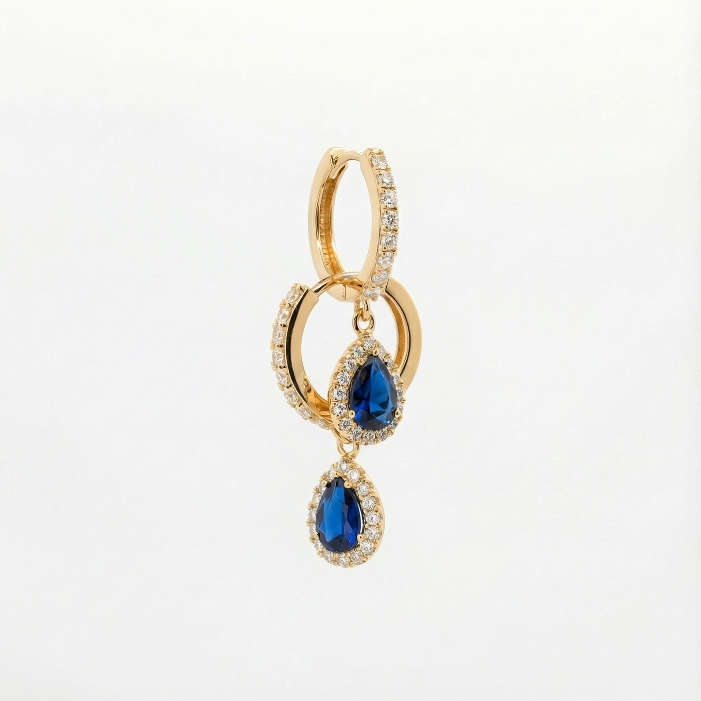 
                  
                    Elara 18ct and 22ct yellow Gold hoop earrings with a sapphire stone-set pear drop, by Karat Goldsmiths
                  
                