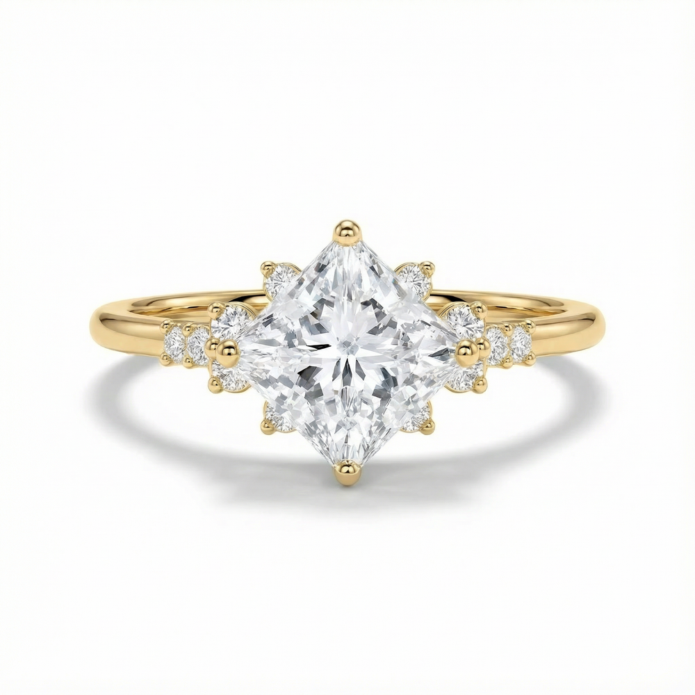 Gold ring with a large princess-cut diamond and small side stones on a white background