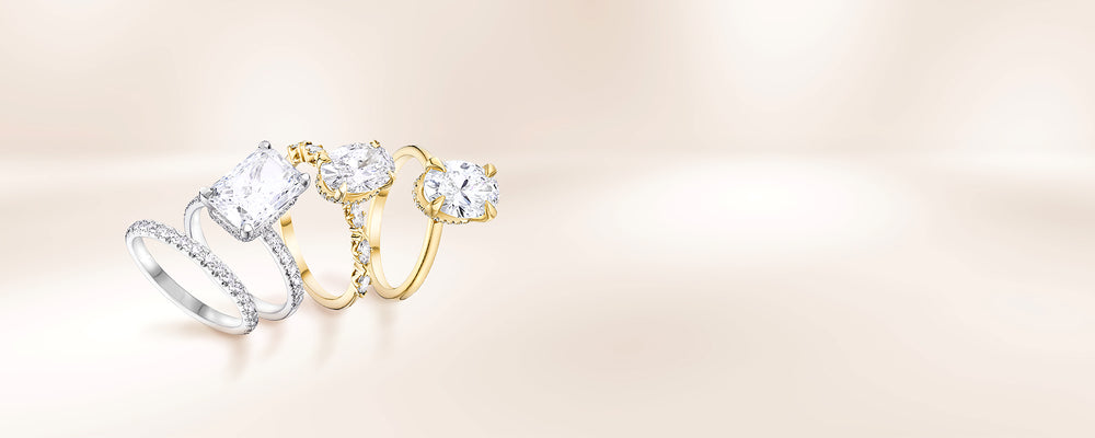 Three diamond engagement rings in white and gold on a soft beige background